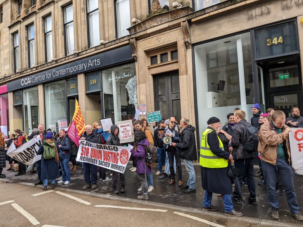 Protestors gather with flags and banners outside the Centre for Contemporary Arts in Glasgow, home to Saramago Cafe.