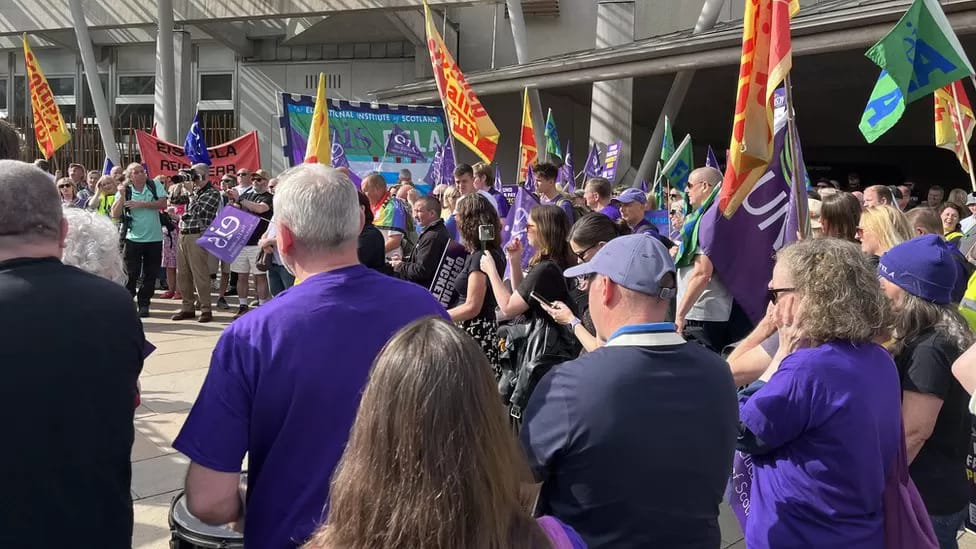 Members of EIS-FELA, UNISON, and the SSP rally outside the Scottish Parliament in Edinburgh